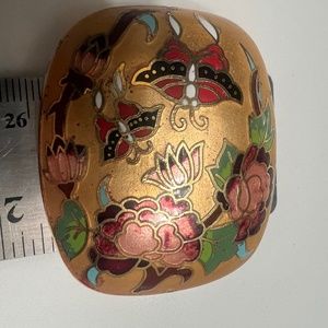 a gold rounded rectangular vintage cloisonné pendant.